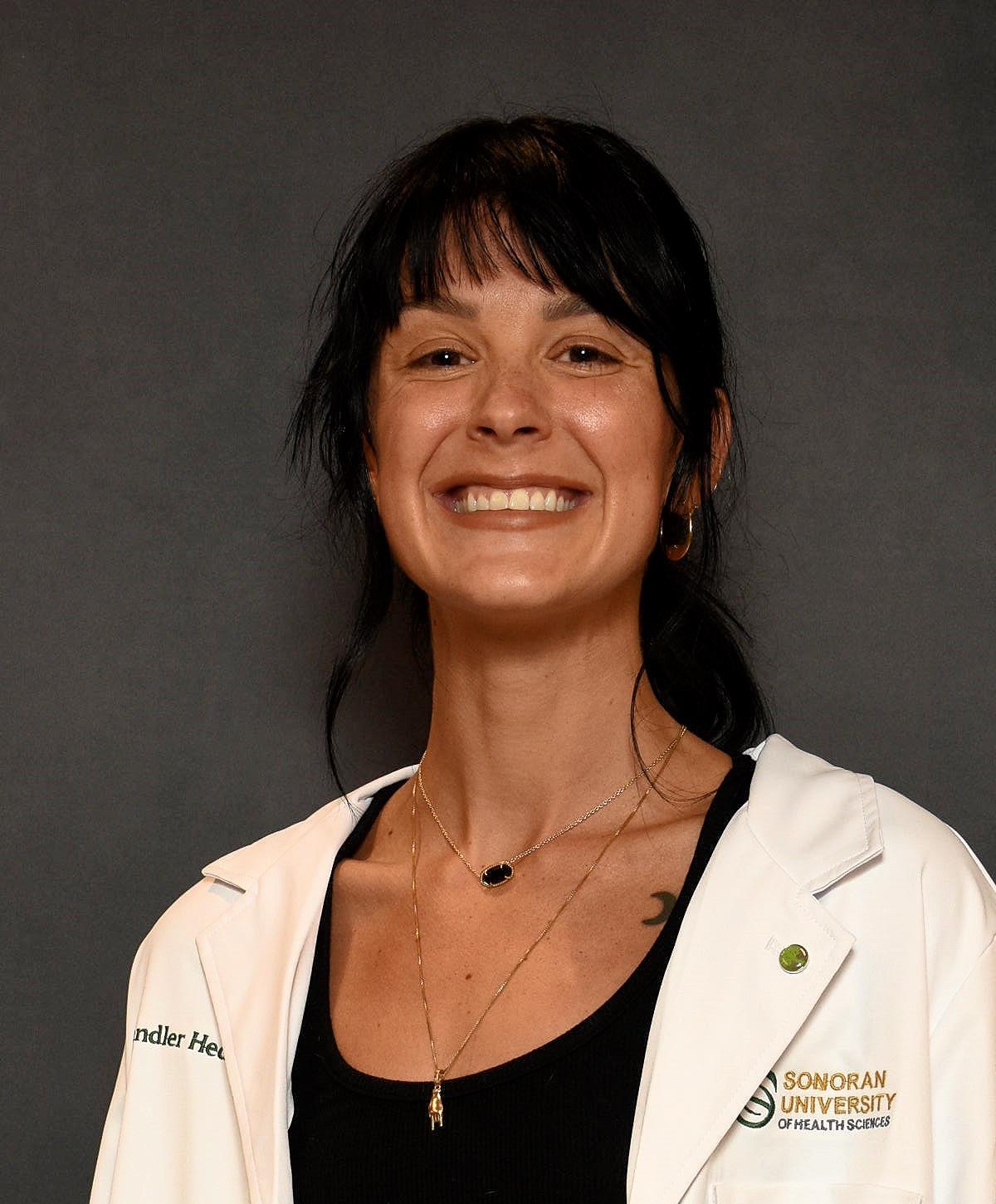 Dr. Chandler Wright in her white coat